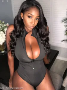Ellie The Empress in a black one-piece bodysuit